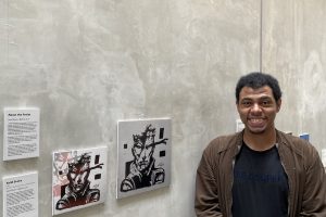 Jamal with his artwork, Solid Snake, displayed at the World Refugee Day exhibition on 20 June 2026.