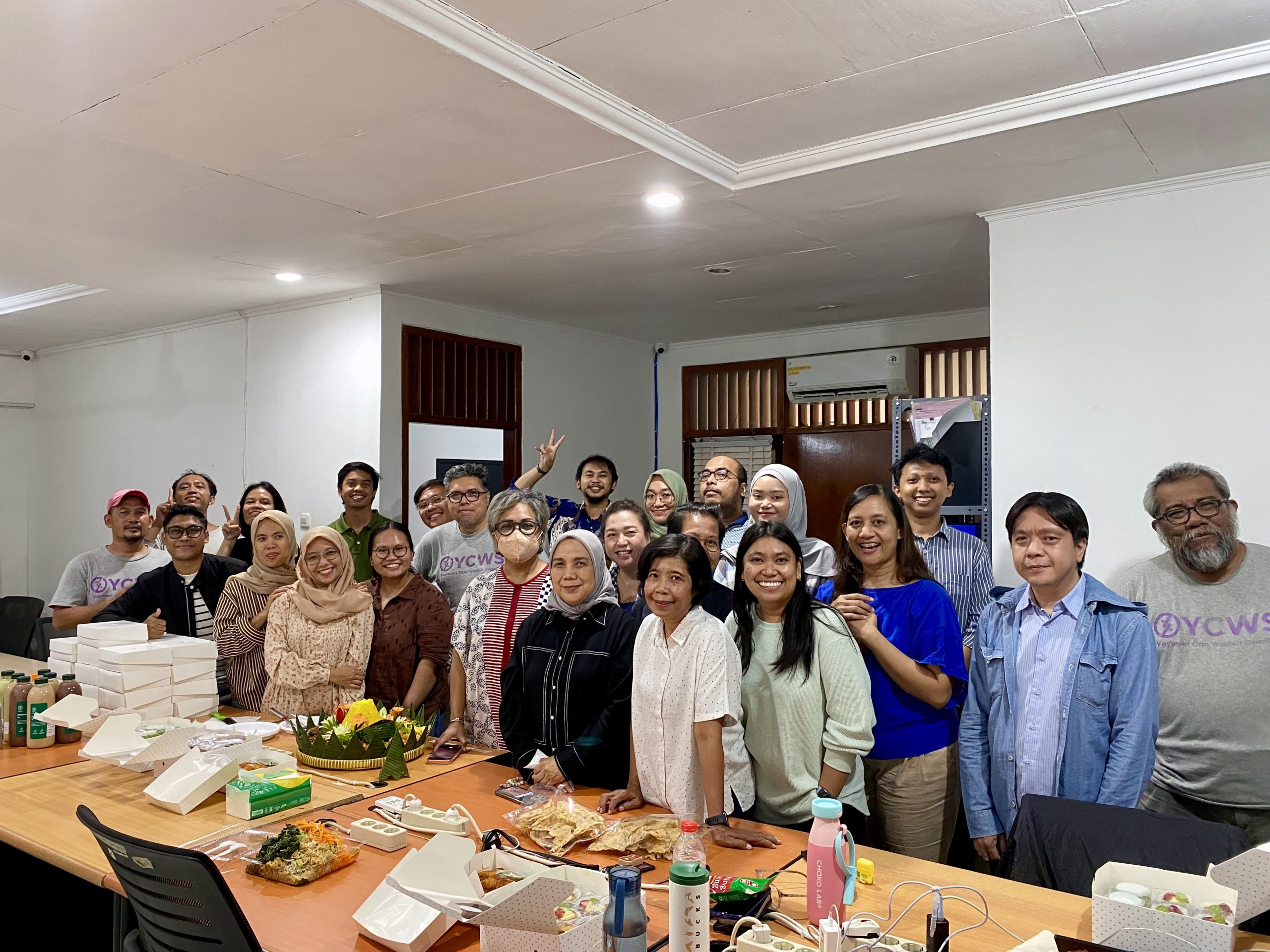 YCWS staff come together to mark the organisation’s second anniversary at the YCWS office. Doc/YCWS.